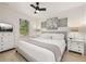 Bedroom with a bed dressed in white and grey tones, light wood floors, and plenty of natural light at 4722 Flagler Beach Way, Kissimmee, FL 34746