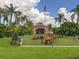 Stately clubhouse with a flag pole, manicured lawn, and colorful landscaping at 4722 Flagler Beach Way, Kissimmee, FL 34746
