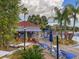 Poolside community bar with lounge chairs, tables, and lush landscaping under a cloudy sky at 4722 Flagler Beach Way, Kissimmee, FL 34746