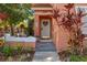 Beautiful front door with tasteful decor, enhanced by lush plants and outdoor lighting at 4722 Flagler Beach Way, Kissimmee, FL 34746