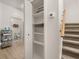 Hallway with closet, open door to bathroom, and stairs leading to the upper level at 4722 Flagler Beach Way, Kissimmee, FL 34746