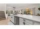 Open-concept kitchen featuring quartz countertops and bar seating leading into the living area at 4722 Flagler Beach Way, Kissimmee, FL 34746