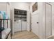 Laundry area features a washer, dryer, storage shelves, and bi-fold closet doors at 4722 Flagler Beach Way, Kissimmee, FL 34746