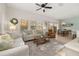 Spacious living room with stylish furnishings, natural light, and an open floor plan to the dining area at 4722 Flagler Beach Way, Kissimmee, FL 34746