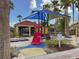 Community playground with slide, shade structure, and surrounding tropical landscaping at 4722 Flagler Beach Way, Kissimmee, FL 34746