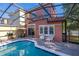 The screened pool and brick paver patio with BBQ grill in a secluded backyard oasis at 4722 Flagler Beach Way, Kissimmee, FL 34746