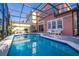 A screened pool and brick paver deck with comfortable lounge chairs in a private backyard at 4722 Flagler Beach Way, Kissimmee, FL 34746