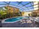 Sparkling pool with a screened-in enclosure, complemented by outdoor furniture and a barbecue grill at 4722 Flagler Beach Way, Kissimmee, FL 34746