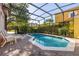Tranquil pool with brick patio area and a screened enclosure, perfect for relaxation and outdoor living at 4722 Flagler Beach Way, Kissimmee, FL 34746