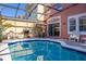 Inviting screened pool with serene blue water and comfortable lounging area with backyard access at 4722 Flagler Beach Way, Kissimmee, FL 34746