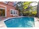 Relaxing pool with a screened enclosure, inviting lounge chairs and a charming patio at 4722 Flagler Beach Way, Kissimmee, FL 34746