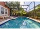 Sparkling pool with inviting lounge chairs and a covered enclosure for year round enjoyment at 4722 Flagler Beach Way, Kissimmee, FL 34746