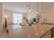 Bright and open kitchen with modern countertop, pendant lighting, and seamless integration with living space at 4835 Memories Ln, Kissimmee, FL 34746
