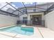 Inviting screened-in pool area with a clear blue pool and relaxing patio area, perfect for outdoor enjoyment at 4835 Memories Ln, Kissimmee, FL 34746