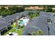 Aerial view of community with pool, palm trees and lush landscaping at 5245 W Irlo Bronson Memorial Hwy # 210, Kissimmee, FL 34746
