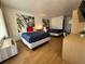 Bright bedroom featuring two beds with blue covers, bamboo art, and laminate floors at 5245 W Irlo Bronson Memorial Hwy # 210, Kissimmee, FL 34746