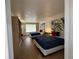 Bright bedroom featuring two beds with blue covers, bamboo art, and laminate floors at 5245 W Irlo Bronson Memorial Hwy # 210, Kissimmee, FL 34746