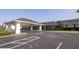 Well-maintained building exterior featuring a porte-cochere entrance and ample parking at 5245 W Irlo Bronson Memorial Hwy # 210, Kissimmee, FL 34746
