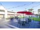 Outdoor patio with black tables and red umbrellas above at 5245 W Irlo Bronson Memorial Hwy # 210, Kissimmee, FL 34746