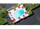 Aerial view of a community pool surrounded by red umbrellas and lounge chairs at 5245 W Irlo Bronson Memorial Hwy # 210, Kissimmee, FL 34746