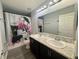 Bathroom with double sinks, modern vanity, stylish shower curtain, and glam decor at 561 Vittorio Dr, Winter Haven, FL 33884