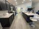 Spacious kitchen features dark cabinets, light countertops, stainless steel appliances, and an island with bar seating at 561 Vittorio Dr, Winter Haven, FL 33884