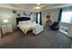 Comfortable main bedroom with a ceiling fan, gray walls, carpet, and furniture at 561 Vittorio Dr, Winter Haven, FL 33884