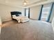Spacious main bedroom with a ceiling fan, gray walls, carpet, furniture, and big windows at 561 Vittorio Dr, Winter Haven, FL 33884