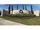 Community entrance signage with manicured landscaping and seasonal decorations, 'Villa Mar' at 561 Vittorio Dr, Winter Haven, FL 33884