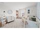 Charming bedroom with pastel-themed decor, including floral wallpaper and a stylish crib and dresser at 6019 Forest Perch Dr, St Cloud, FL 34771
