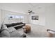 Upstairs bonus room with lake view, ceiling fan, and a large sectional sofa at 6019 Forest Perch Dr, St Cloud, FL 34771