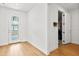 Bright foyer with a glass-paneled door and wood-look flooring, leading to a garage with visible car at 6019 Forest Perch Dr, St Cloud, FL 34771