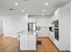 Bright kitchen features white cabinetry, stainless steel appliances, large island with seating at 6019 Forest Perch Dr, St Cloud, FL 34771
