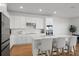 Modern kitchen with white cabinets, quartz countertops, a kitchen island with seating, and stainless steel appliances at 6019 Forest Perch Dr, St Cloud, FL 34771