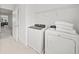 Efficient laundry room with modern washer and dryer, plus practical storage at 6019 Forest Perch Dr, St Cloud, FL 34771