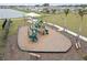 Community playground featuring a slide, climbing structure, and mulch ground cover at 6019 Forest Perch Dr, St Cloud, FL 34771