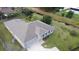 Aerial view of a single-Gathering home with gray roof, green lawn, and a long driveway at 650 Mesilla Dr, Kissimmee, FL 34758