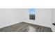 Cozy bedroom features gray floors, white walls, a window with natural light, and a peaceful view at 650 Mesilla Dr, Kissimmee, FL 34758