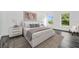 Comfortable bedroom with hardwood floors, a cozy rug, white furniture, and relaxing window views at 650 Mesilla Dr, Kissimmee, FL 34758