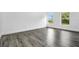 Light, bright bedroom with wood-look flooring, and two windows with views to the fenced backyard at 650 Mesilla Dr, Kissimmee, FL 34758
