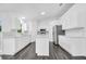 Kitchen with white cabinetry, stainless steel appliances, and a quartz countertop island at 650 Mesilla Dr, Kissimmee, FL 34758