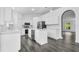 Bright kitchen with a center island, stainless steel appliances, and wood-look flooring at 650 Mesilla Dr, Kissimmee, FL 34758