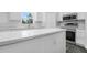 A bright kitchen featuring quartz countertops and stainless steel appliances at 650 Mesilla Dr, Kissimmee, FL 34758
