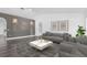 Bright living room with neutral décor, gray accent wall, stylish lighting, and contemporary furnishings at 650 Mesilla Dr, Kissimmee, FL 34758
