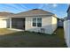 Exterior shot of the home's backyard, with a screened-in lanai and small table at 6783 Grace Hammock Rd, Harmony, FL 34773