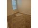 Bedroom featuring neutral carpeting and a window for natural light at 6783 Grace Hammock Rd, Harmony, FL 34773