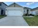 Charming single-Gathering home with a well-manicured lawn and an attached two-car garage at 6783 Grace Hammock Rd, Harmony, FL 34773