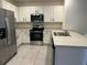 Modern kitchen featuring stainless steel appliances, white cabinets, and a spacious countertop at 6783 Grace Hammock Rd, Harmony, FL 34773