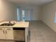 Open-concept kitchen with stainless steel appliances seamlessly connected to the dining area at 6783 Grace Hammock Rd, Harmony, FL 34773
