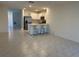 Open-concept kitchen with stainless steel appliances and a breakfast bar at 6783 Grace Hammock Rd, Harmony, FL 34773